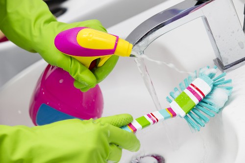 Upholstery cleaner treating a fabric sofa in W9