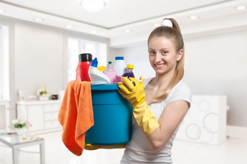 Local technician cleaning a hob and oven in W9